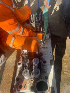 The replacement cylinder head begin connected up for craning into the loco. Photo by Georgia Williams