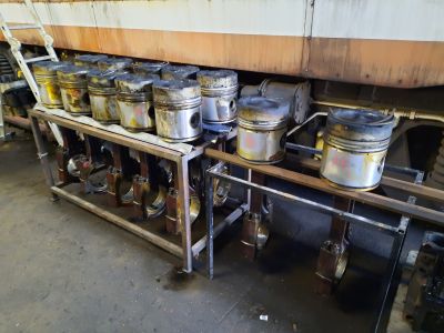 The pistons sat in the table waiting for their rings to be removed. Photo by James Whincup