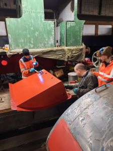 Many hands make light work of painting the fuel tank in primer. Photo by James Whincup