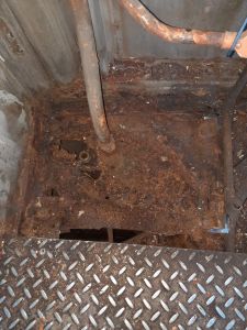 The rotten floor and the remains of the legs as the bolts wouldn't come out. Photo by James Whincup