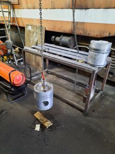 The second piston is warmed hanging from the crane. Photo by James Whincup