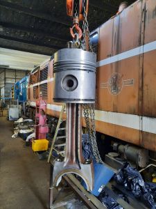 The piston and connecting rod being lifted ready for fitting. Photo by James Whincup