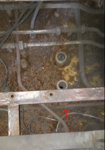 The view under the driver seat in no.1 cab after the muck and rust was cleaned out. The arrow shows where the first leak came from. Photo by James Whincup